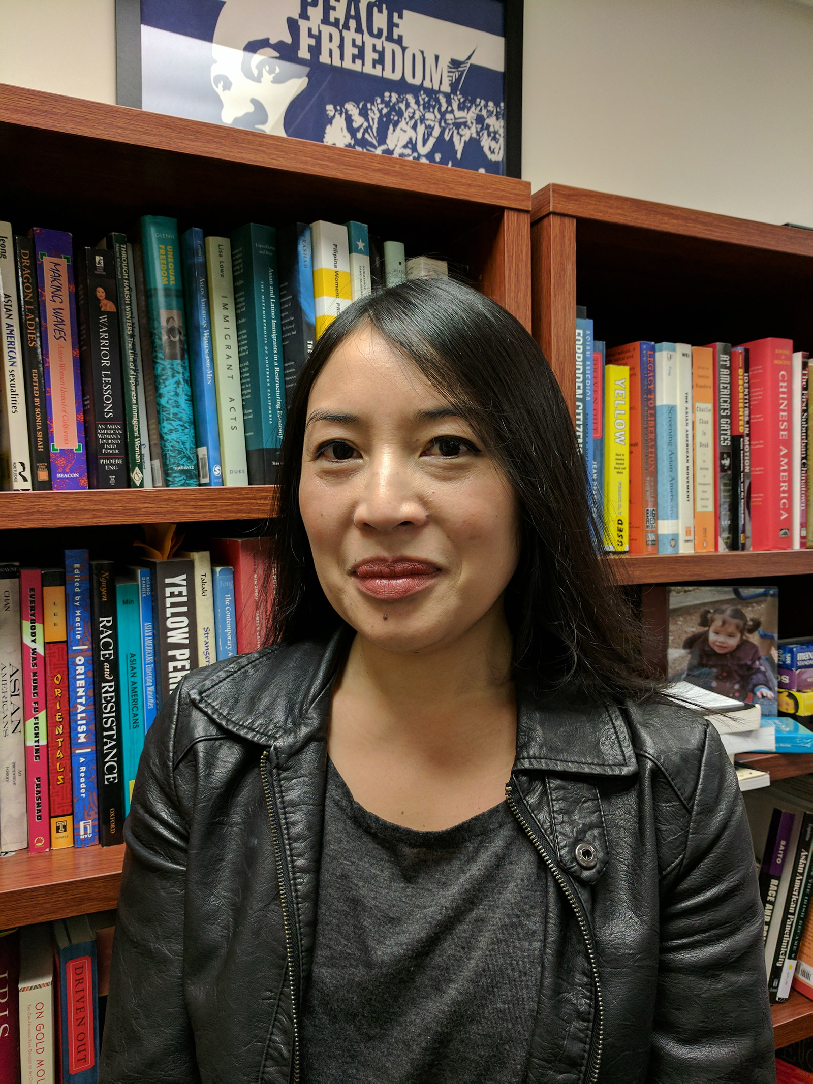 Janelle Wong standing in front of a book shelf