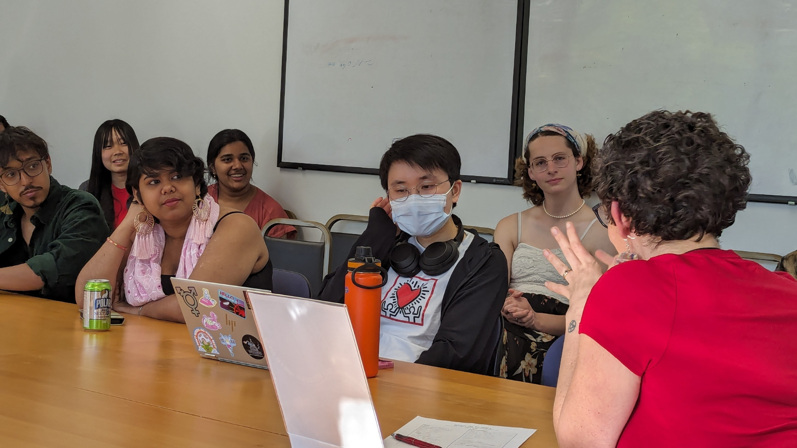 A group of students actively listens during a presentation