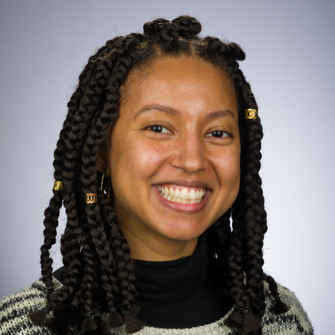 Rebekah Otto smiles for camera against a neutral background